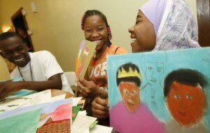 Refugees from Kenya living on the West Side, from left, Yonis Osman, 17; Safiya Osman, 15; and Habiba Noor, 14, each selected an East African folktale to illustrate for a recently published book. Before setting pencil to paper, the youths analyzed and enacted their stories. Derek Gee / Buffalo News