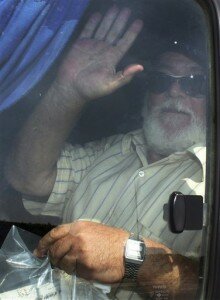 Egyptian fishing boat owner Hassan Khalil, whose crew overpowered pirates off the Somali coast, waves from a bus after arriving back to a hero's welcome by family and friends at the airport in Cairo, Egypt Tuesday, Aug. 18, 2009. The fishermen on Khalil's boat, the Momtaz 1, and another vessel rose up against their captors and succeeded in killing two of them, taking the rest hostage, though Khalil's role is unclear and he may have hired Somali militiamen to help free his men. (AP Photo/Ahmed Ali)