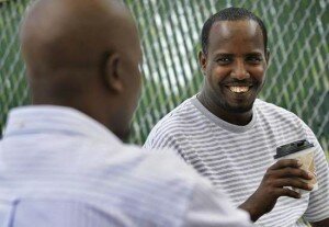 St. Cloud resident Ahmed Abdulle (right) spends part of Thursday afternoon sipping his coffee and listening to his friend Abdihaye Hamsshi tell a story at the 33rd Meat & Grocery in St. Cloud. (Kimm Anderson, kanderson@stcloudtimes.com)